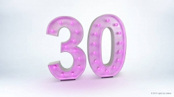 Illuminated pink number "30" on a white background.
