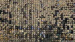 Mosaic of numerous small triangular images forms a large rectangular collage with varying shades and patterns.