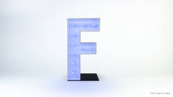 A large illuminated letter "F" on a black base against a white background.