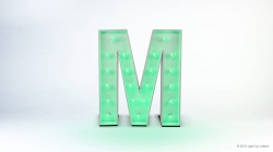A large, illuminated letter M with green lights stands on a white background.
