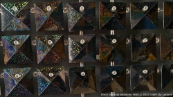 A grid of black holographic tiles with metallic buttons, displaying a range of reflective colors.