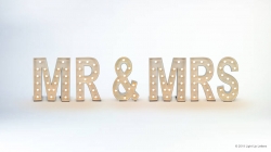 Illuminated letters spell "MR & MRS" against a plain background.