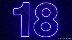 Neon blue number "18" on a dark background.