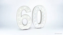 Illuminated number "60" on a plain background.
