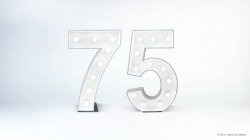 Illuminated marquee lights forming the number 75 against a plain background.