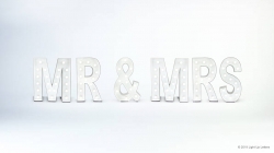 Illuminated letters spell "MR & MRS" against a plain white background.