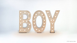 Illuminated marquee letters spelling "BOY" with white bulbs on a white background.