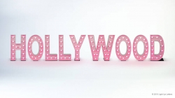 Pink "HOLLYWOOD" sign with marquee lights on a white background.