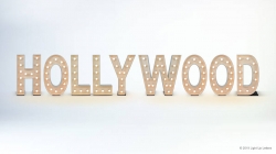 Lighted letters spelling "HOLLYWOOD" against a plain background.