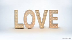 Illuminated letters spelling "LOVE" on a white background.