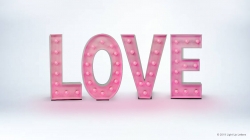 Pink marquee letters spell "LOVE" on a light gray background.