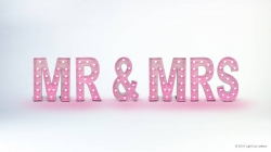 Pink marquee letters spell "MR & MRS" with a light glow against a white background.
