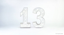 Illuminated marquee numbers displaying "13" on a plain white background.