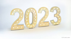 Illuminated numbers displaying "2023" with glowing lights, set against a light background.