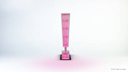 Pink exclamation mark sculpture on a display stand against a white background.