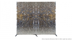 A large grid-like artwork with a symmetrical design in various shades of brown, blue, and gold on a white background. It is supported by three stands.